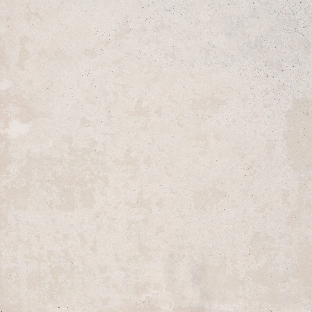 A close-up of a beige, textured surface with subtle speckles. The coloration is uniform, giving an appearance similar to sandstone or plaster. The texture includes small variations in tone, adding a slightly mottled effect.