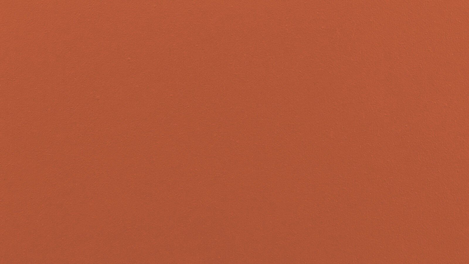 A uniformly textured solid orange background with no discernible patterns or objects.