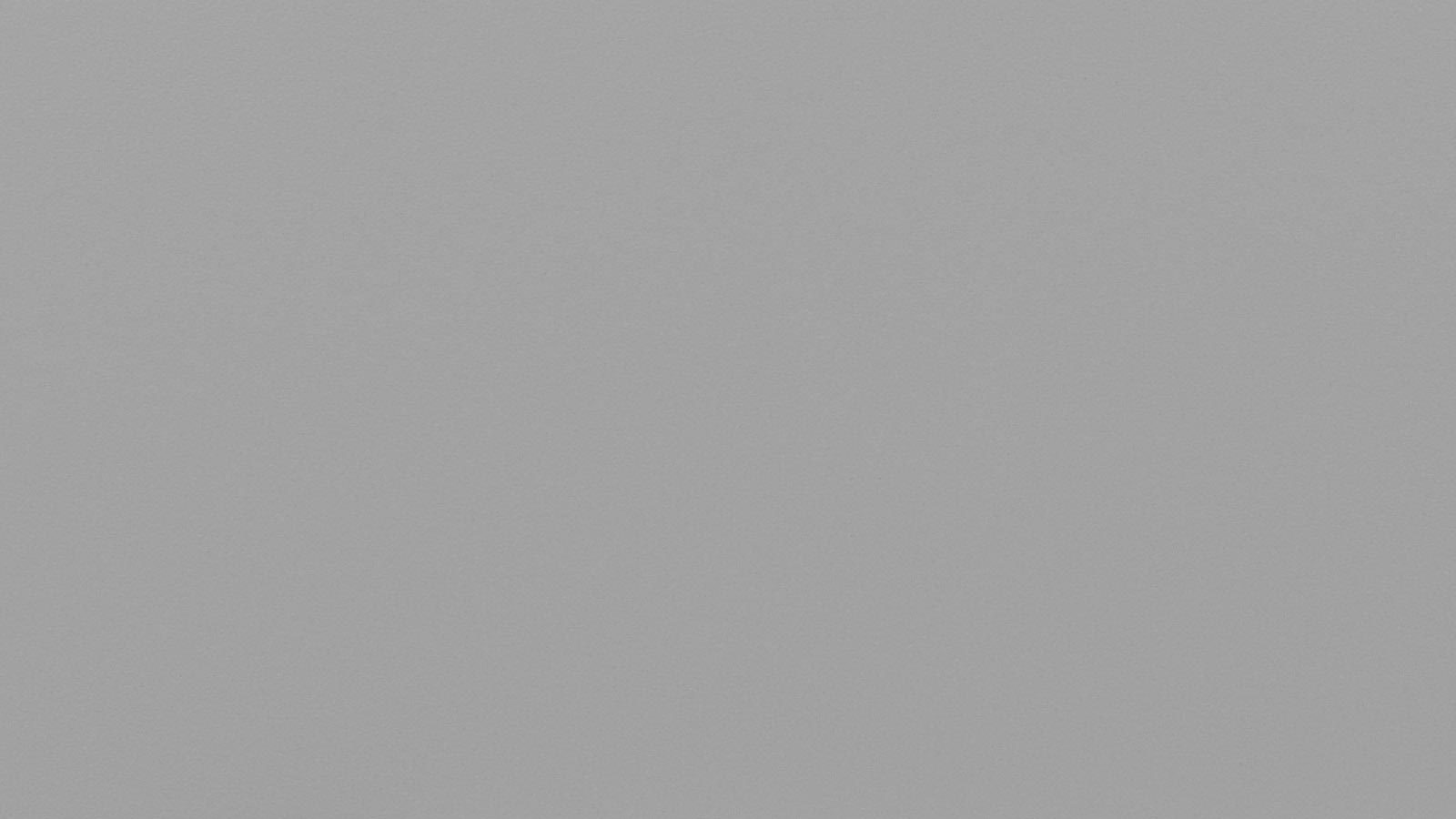 A plain, light gray, textured surface fills the entire frame with no distinguishable features or objects.