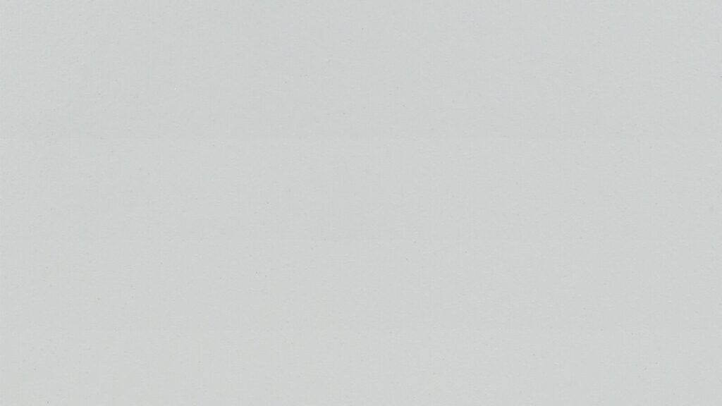 A blank, light gray, textured surface. There are no discernible patterns or objects present in the image, giving it a minimalist and neutral appearance.