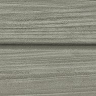 A close-up image of wooden siding painted in a muted gray color. The wood grain is visible, with horizontal lines and a slightly rough texture, showing a subtle variation in shades of gray along the planks.